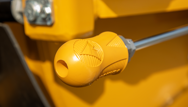 A close up of a yellow Vermeer quick dig nozzle for vacuum excavation